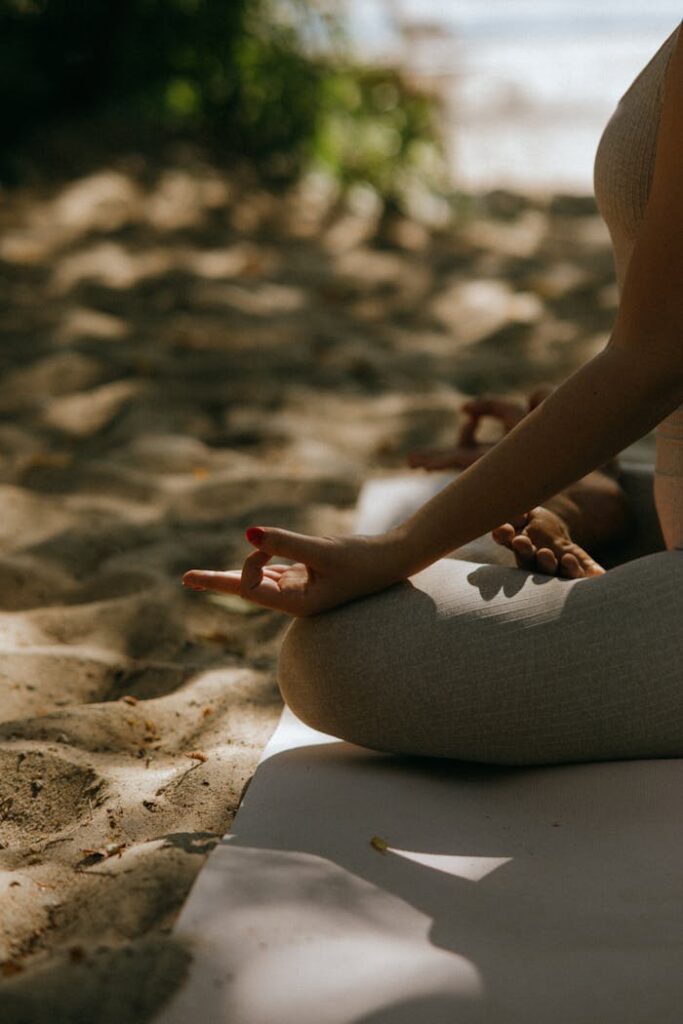 pexels-photo-8534279 A peaceful scene of meditative yoga practice on a sandy beach.