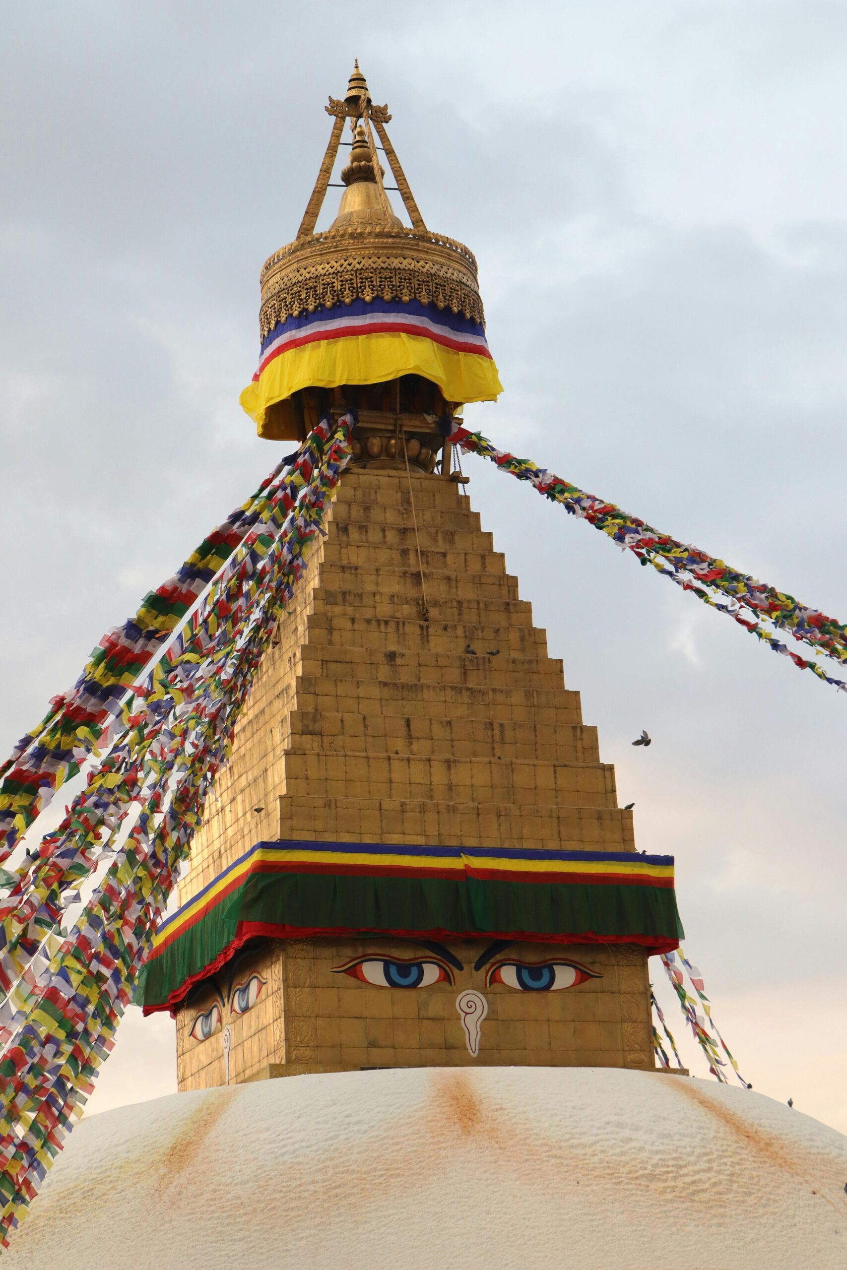Captured at twilight, the iconic Boudhanath Stupa is adorned with vibrant prayer flags, offering a serene ambiance.