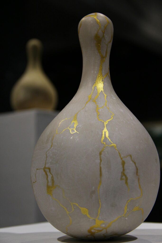 pexels-photo-15050454-15050454 A close-up of an elegant ceramic vase featuring gold kintsugi on exhibit.