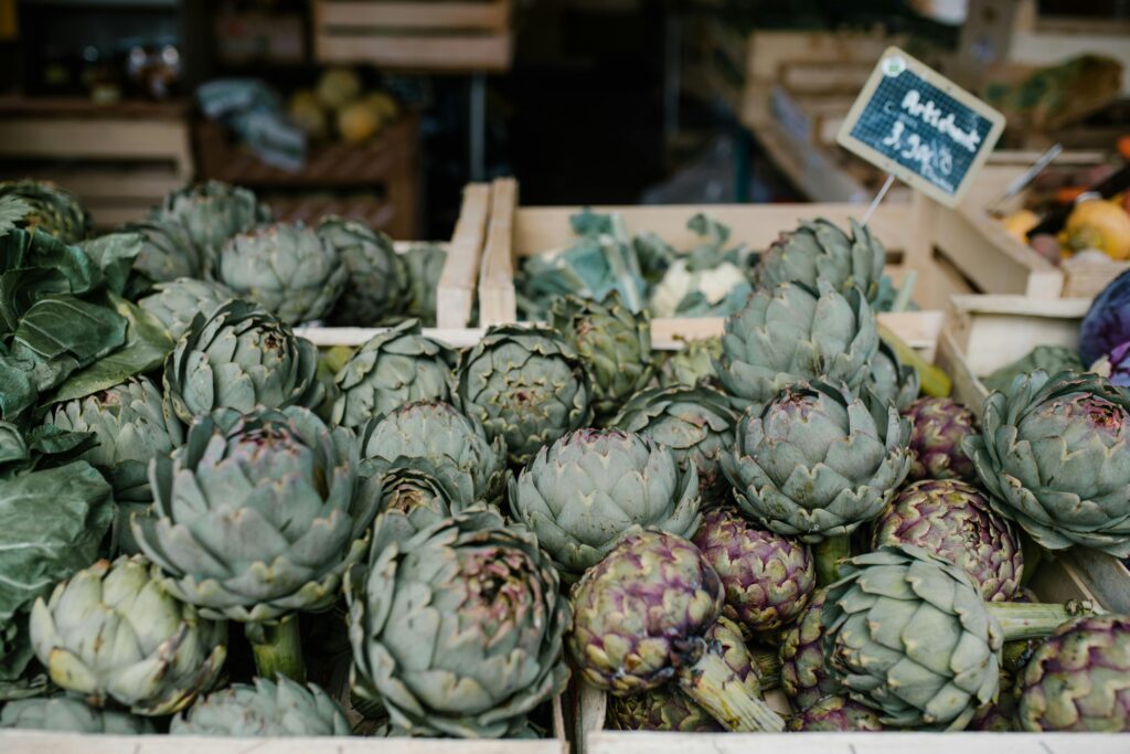 A selection of fresh artichokes displayed at a local market in Paris, France.